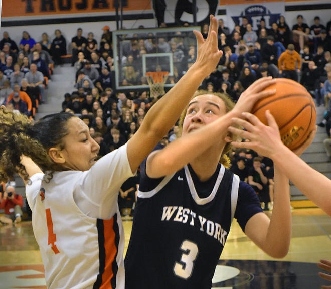 West York's Faith Walker (3) tries to shoot over York Suburban's Janay Rissmiller during the District 3 Class 5A girls' basketball semifinals on Tuesday, Feb. 27, 2024, at York Suburban High School. The host Trojans emerged with a thrilling 37-34 victory.