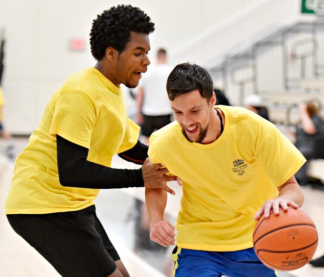 Brendon Allison, right, of Hanover, works to get around J’Den English, of West York, as they compete in basketball during the Special Olympics Spring Games at Grumbacher Sport and Fitness Center on the York College of Pennsylvania Campus in Spring Garden Township, Saturday, May 4, 2024. (Dawn J. Sagert/The York Dispatch)