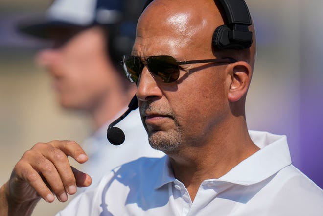Penn State head coach James Franklin adjusts his headset during the first half of an NCAA college football game against Northwestern, Saturday, Sept. 30, 2023, in Evanston, Ill. (AP Photo/Erin Hooley)