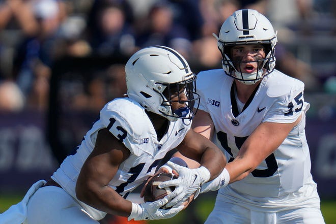 Penn State quarterback Drew Allar, right, hands the ball off to running back Kaytron Allen during the first half of an NCAA college football game against Northwestern, Saturday, Sept. 30, 2023, in Evanston, Ill. (AP Photo/Erin Hooley)