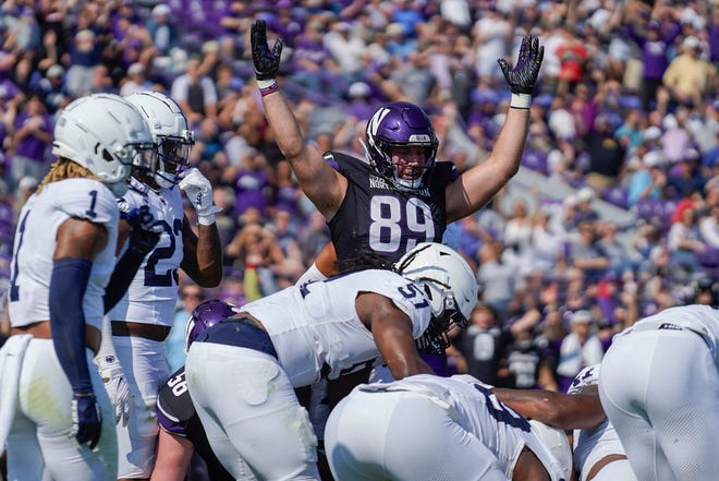 Northwestern tight end Charlie Mangieri throws up his hands as quarterback Ben Bryant runs in a one-yard touchdown during the first half of an NCAA college football game against Penn State, Saturday, Sept. 30, 2023, in Evanston, Ill. (AP Photo/Erin Hooley)