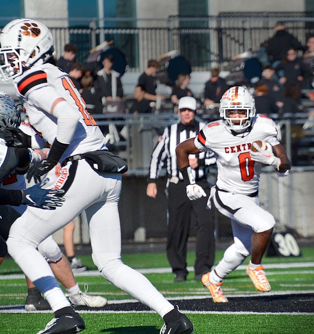 Central York's Juelz Goff (0) follows the block of Preston Fink (12) during Saturday's District 3 Class 6A semifinal football game at Harrisburg. The host Cougars held off a late charge to win 28-21 and end the Panthers' season.