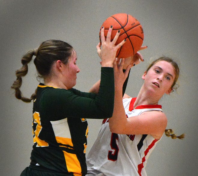 York Catholic's Meredith Smith (32) and Susquehannock's Erin Jackson both go for a rebound during Panther Holiday Tournament girls' basketball semifinal action on Wednesday, Dec. 27, 2023, at Central York High School. The Fighting Irish won, 59-38, to advance to Thursday's final against Central York.