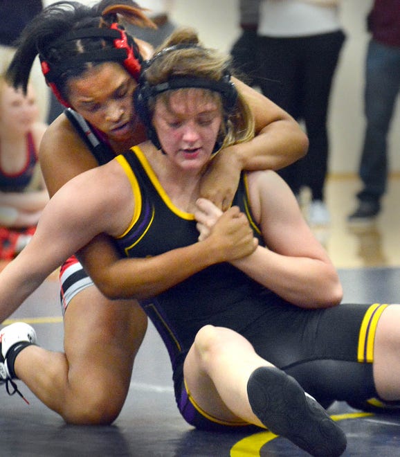 Dover's Jahzari Abney, left, dropped a 10-6 decision to Ahnika Hoover of Boiling Springs in the 142-pound class at the PIAA District 3 girls' wrestling tournament at Penn Manor High School in Millersville on Saturday, March 2, 2024.
