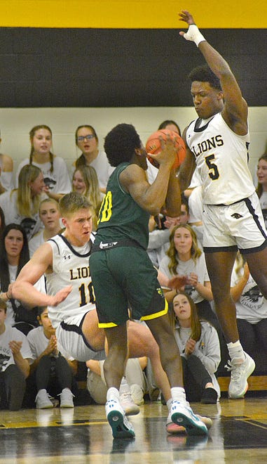 Red Lion's Chris Williams, right, tries to block Emmaus' Jametric Harris as Joe Sedora (10) hits the floor during a PIAA Class 6A boys' basketball first-round playoff game Saturday, March 9, 2024, at Red Lion High School. The Lions won, 78-65.