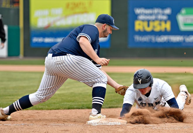 Penn State York’s Gavin Constein, right, dives back to first to avoid a pickoff attempt by Penn State Scranton’s Zach Benson during baseball action at WellSpan Park in York City, Friday, March 22, 2024. Penn State York would win the first game in the afternoon doubleheader 4-1. (Dawn J. Sagert/The York Dispatch)