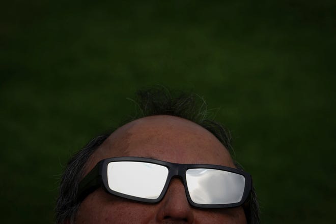 Joe Solis looks at the sun ahead of a total solar eclipse at Eagle Pass Student Activities Center, Monday, April 8, 2024, in Eagle Pass, Texas. (Jon Shapley/Houston Chronicle via AP)
