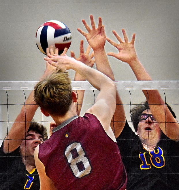 New Oxford's Tanner Haugh (8) blasts a ball into the block of Kennard-Dale's Andy Ester and Nicholas Gaumer during York-Adams League boys' volleyball action Thursday, April 11, 2024, at New Oxford. The Colonials swept the Rams, 3-0.