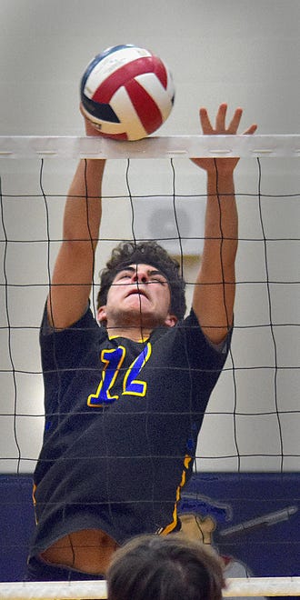 Kennard-Dale's Cole Yates (12) goes for the block against New Oxford during York-Adams League boys' volleyball action Thursday, April 11, 2024, at New Oxford. The Colonials swept the Rams, 3-0.