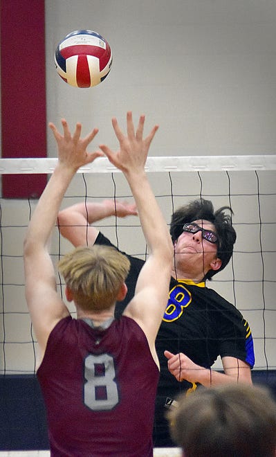 Kennard-Dale's Andy Ester spikes the ball as New Oxford's Tanner Haugh defends during York-Adams League boys' volleyball action Thursday, April 11, 2024, at New Oxford. The Colonials swept the Rams, 3-0.