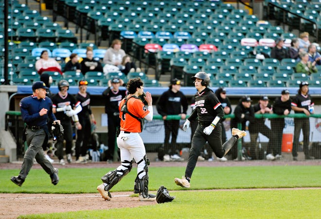 Central York’s Aaron Lecorchick, front, looks to catch the ball as South Western’s Carlos Caraballo scores a run during the Crushing Cancer baseball fundraising event at WellSpan Park in York City, Friday, April 12, 2024. South Western would win the game 7-2. (Dawn J. Sagert/The York Dispatch)