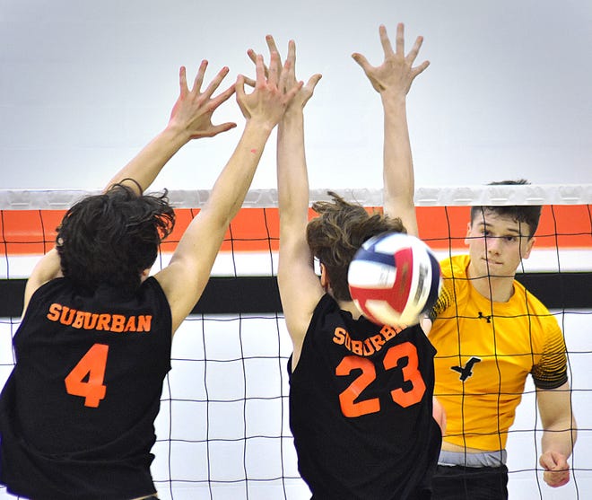 Red Lion's Tyler Good, right, slams the ball past two York Suburban blockers during York-Adams League boys' volleyball action Wednesday, April 17, 2024, at York Suburban High School. The visiting Lions earned a 3-0 sweep of the Trojans.