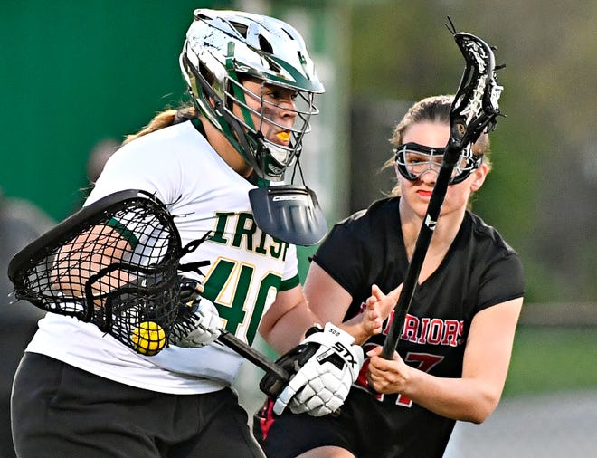 York Catholic’s Amanda Reed, left, controls the ball while Susquehannock’s Mackenzie Dryden defends during girls’ lacrosse action at York Catholic High School in York City, Thursday, April 18, 2024. York Catholic would win the game 8-4. (Dawn J. Sagert/The York Dispatch)
