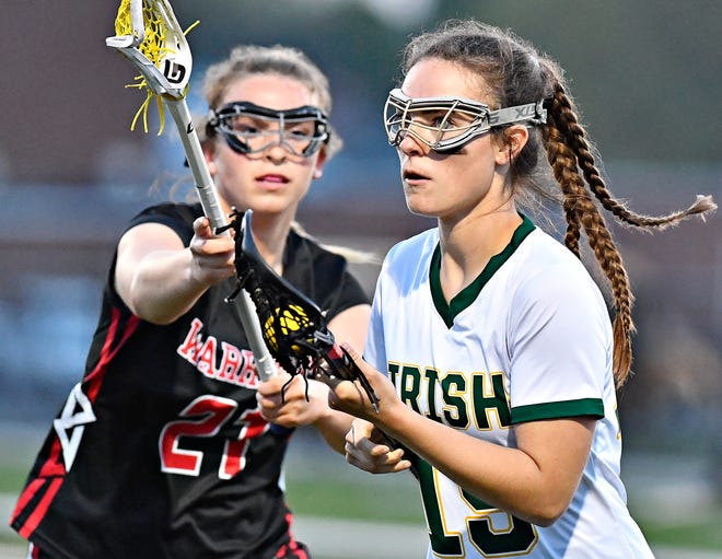 York Catholic’s Molly Janusz, right, moves the ball down the field while Susquehannock’s Erin Jackson defends during girls’ lacrosse action at York Catholic High School in York City, Thursday, April 18, 2024. York Catholic would win the game 8-4. (Dawn J. Sagert/The York Dispatch)
