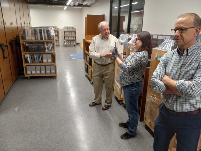 Dick Michaelian with Relocation Consulting and Management in Mechanicsburg talks with York History Center Library and Archives Director Nicole Smith and Vice President of PR and Marketing Dan Fink as archival material is placed in the new facility on North Pershing Ave.
