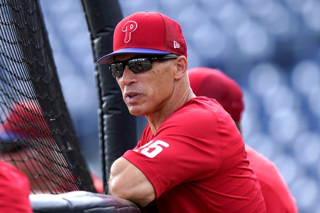 Philadelphia Phillies manager Joe Girardi watches players work out before a spring training baseball game against the Toronto Blue Jays, Wednesday, March 23, 2022, in Clearwater, Fla. (AP Photo/Lynne Sladky)