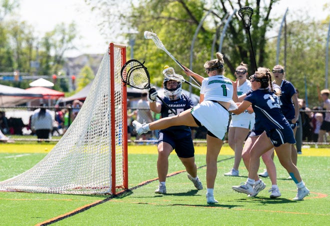 York College's Gianna Huet (1) on goal against Messiah's Mackenzie O'Haver (25) during the Commonwealth Women's Lacrosse Final in York on Saturday, May 6, 2023.
