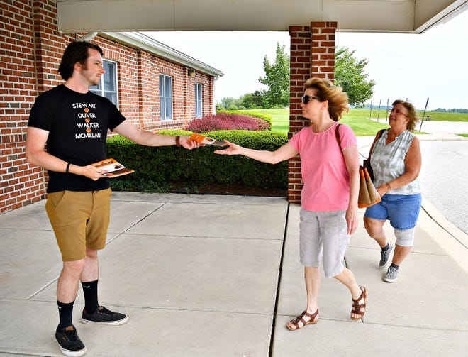 David Krebs, of York Township, promotes the Citizens for Central York School Board as he hands flyers to Robin Pappas and Pam Goodwin, both of Manchester Township, during Primary Election Day at the Zion Lutheran Church polling location in Manchester Township, Tuesday, May 16, 2023. Dawn J. Sagert photo